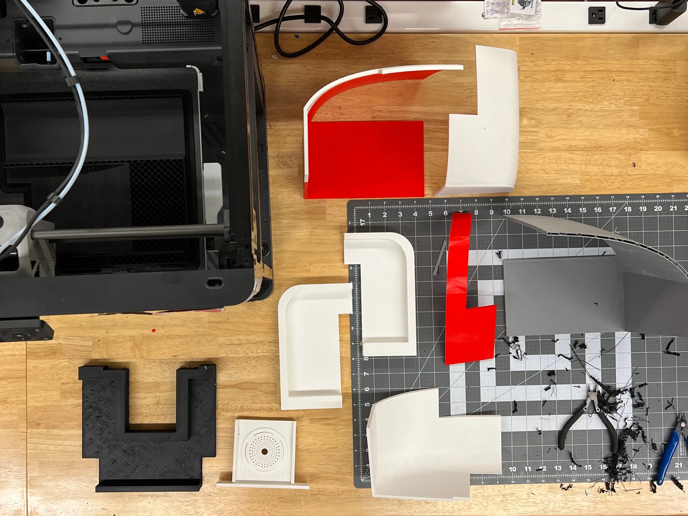3D-printed prototype parts laid out on a workbench