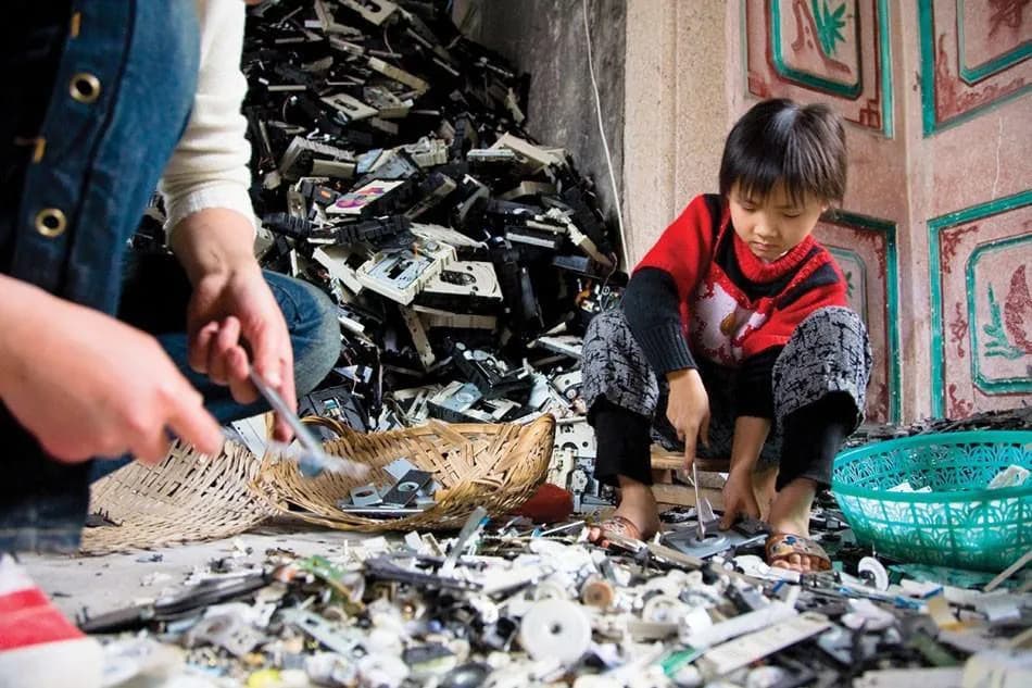 Children sorting through piles of electronic waste